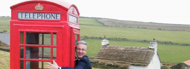 Juan Kelly hugs a phone box